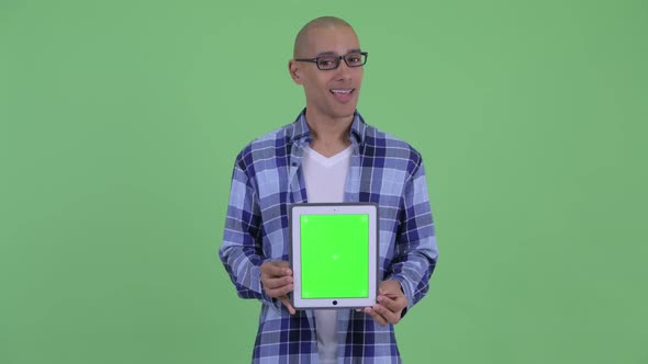 Happy Bald Hipster Man Talking While Showing Digital Tablet