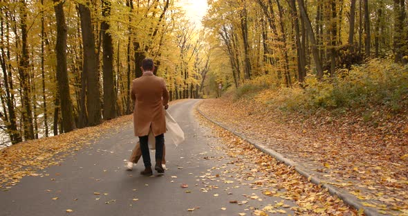 Young Couple in Beige Clothes in the Autumn Park