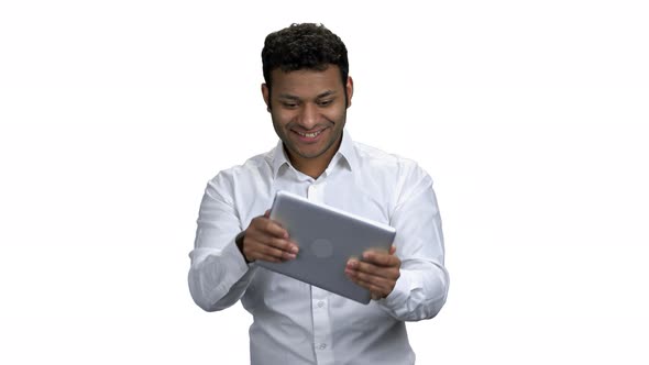 Funny Indian Guy Playing Game on Digital Tablet
