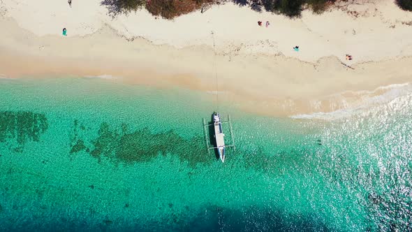 Tropical birds eye copy space shot of a sunshine white sandy paradise beach and aqua blue ocean back