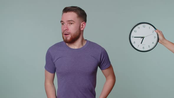 Confused Man with Anxiety Checking Time on Clock Running Late to Work Being in Delay Deadline