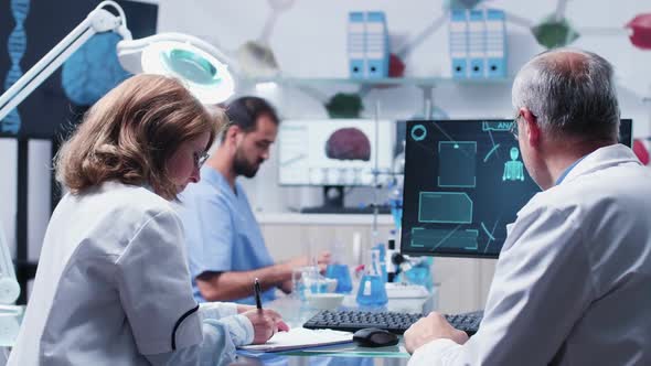 Team of Scientists Working in Busy Laboratory