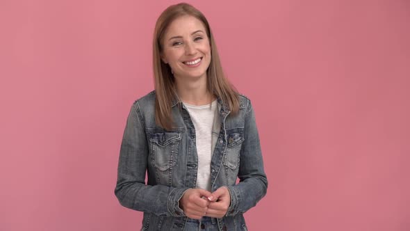 Cute caucasian woman looking straight into the camera and telling something.