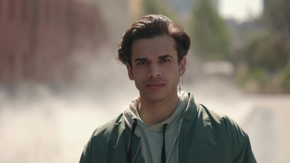 Guy with Piercing Standing Outdoors and Looking at Camera