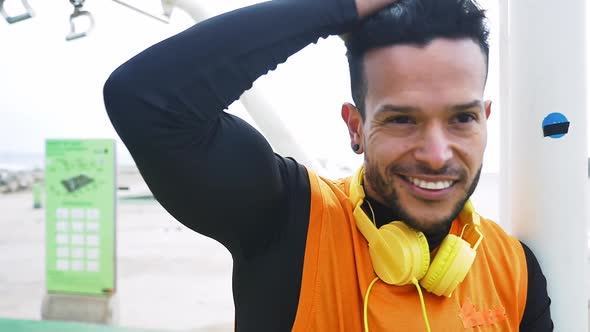 Man training at the beach outdoor gym