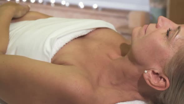 A Relaxed Woman Is on the Treatment in the Spa Salon