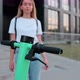Attractive woman take electric bike walking on street modern town. - VideoHive Item for Sale