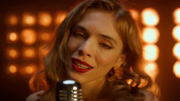 Portrait Woman Singing Microphone in Nightclub Lights