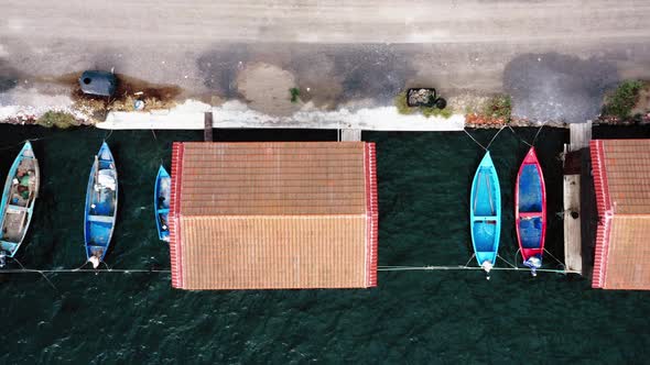 Top view of fishing huts with moored boats.