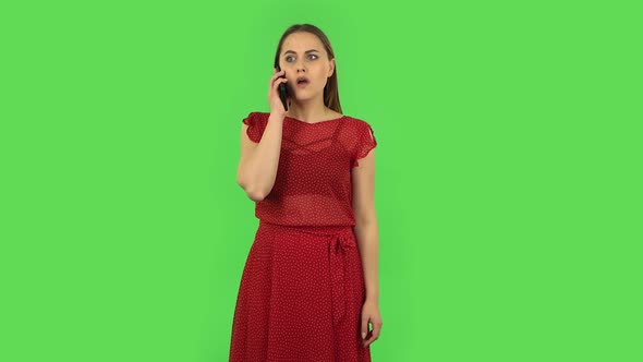 Tender Girl in Red Dress Is Talking for Mobile and Shocked Then Dissatisfied. Green Screen