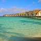 Slow motion traveling along tropical beach with overwater bungalow - VideoHive Item for Sale