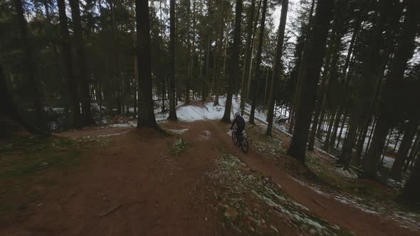 Drone On Cyclist In Snow Forest