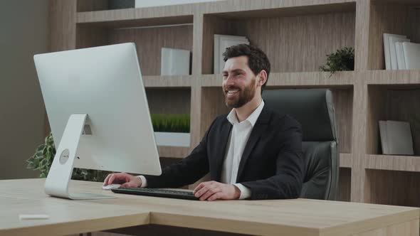 CEO Smiling Looking at His Screen