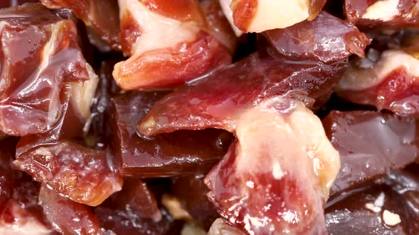 Serrano ham chopped in small pieces close up view, macro shot in 4k.