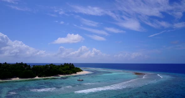 Wide angle fly over abstract shot of a sandy white paradise beach and turquoise sea background 