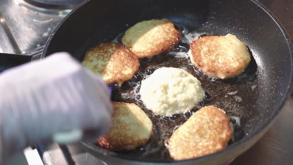 Preparation of golden crispy potato pancakes in a frying pan. Vegetable fritters.