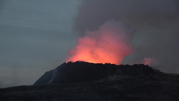 Volcanic eruption in Iceland. Impressive view of the exploding red lava from the Active Volcano.