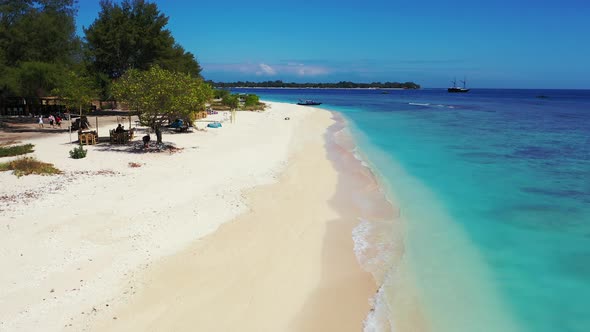 Daytime aerial tourism shot of a summer white paradise sand beach and aqua blue ocean background in 