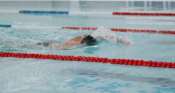 Young Athletic Man Swimmer Swims in the Pool, Man Swimming and Training in the Water, Slow Motion