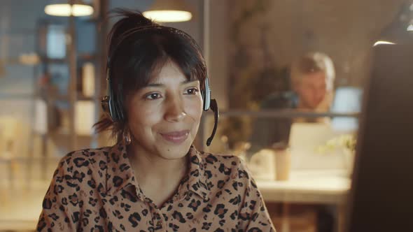 Hispanic Businesswoman Working in Call Center at Night