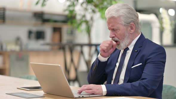 Sick Senior Old Businessman with Laptop Coughing