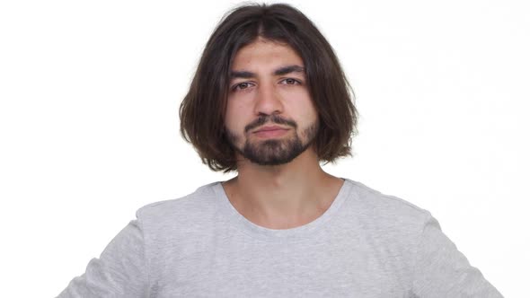 Concetrated Guy Pointing to Look Into His Eyes Isolated Over White Background in Slowmotion