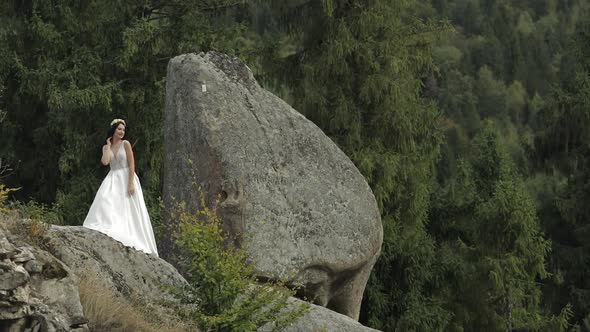 Beautiful and Lovely Bride Standing on the Mountain Hills. Woman in Love