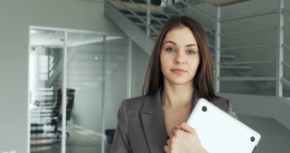 Young Business Woman Walking in Office Hall Corridor. Serious Attractive Female Goes To Conference