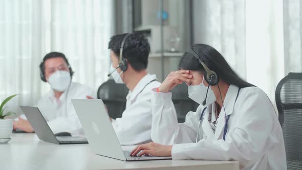 A Woman Doctor In Mask Working As Call Centre Agent Headache Because Her Colleagues Are Talking