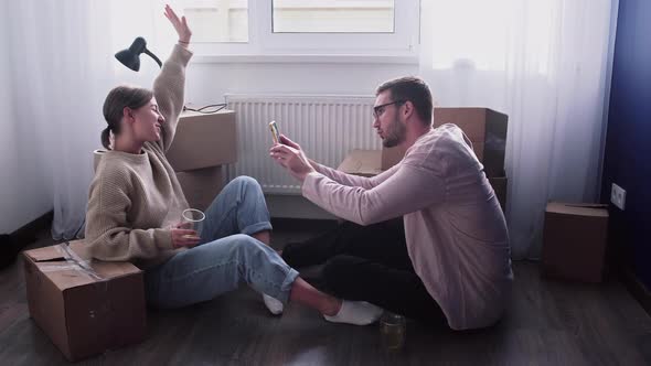 Happy Couple Relaxes After Moving in a New Home