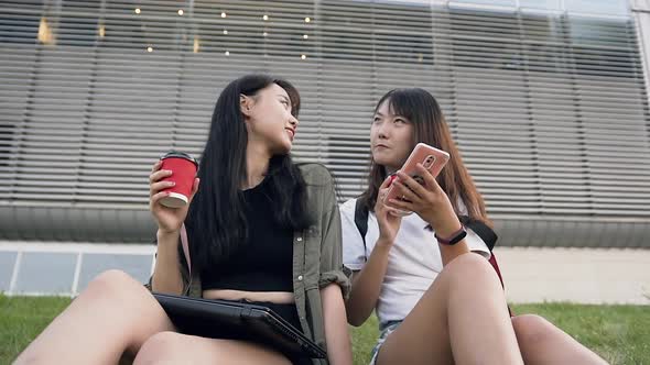 Asian Girls Spending their Time Together, Sitting on the Grass