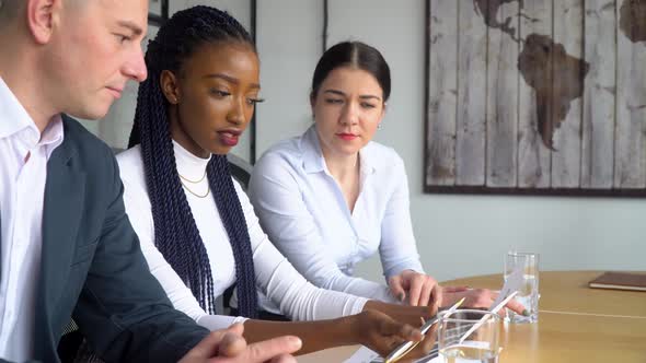 Beautiful African American Businesswoman Consults to His Multiracial Subordinates About Documents