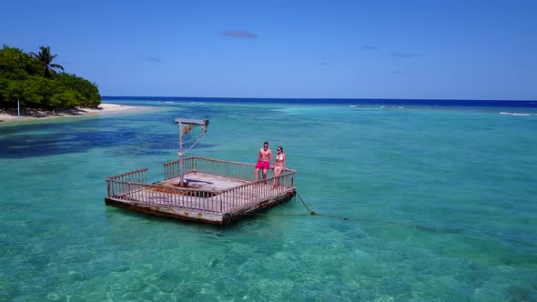 Romantic lady and man on romantic honeymoon spend quality time on beach on clean white sand 