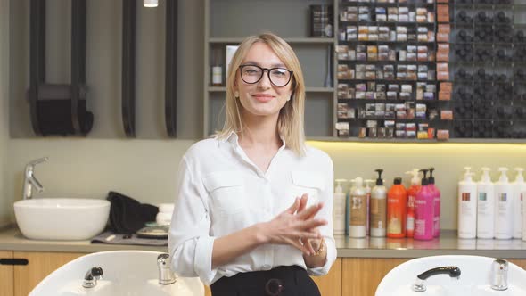 Young and Beautiful Caucasian Woman Seller or Consultant in Beauty Saloon