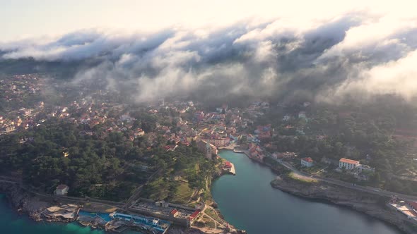 Aerial view above the clouds of Veli Losinj cityscape, Croatia.