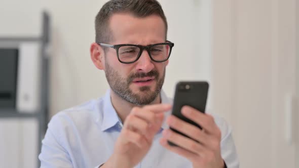 Portrait of Middle Aged Man Having Loss on Smartphone