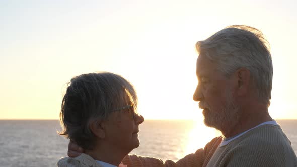 Portrait of couple of two happy seniors and mature and old people at the beach together