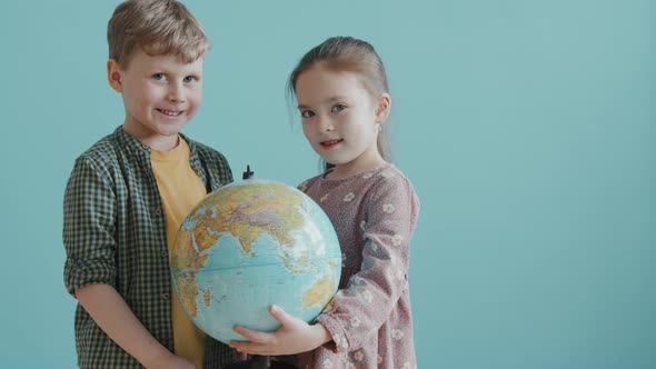 Portrait of Adorable Girl and Boy with World Globe