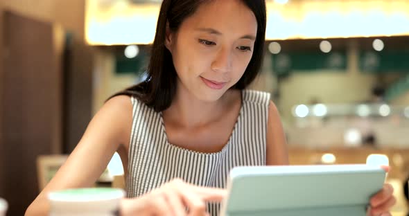 Young Woman making order on tablet inside restaurant