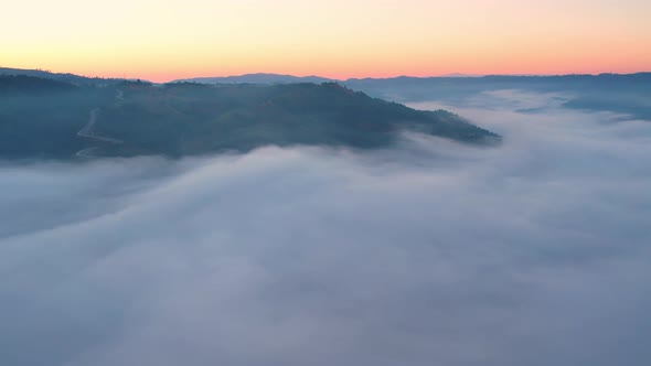 4K Aerial video Beautiful sunrise above dense clouds and fog in the morning