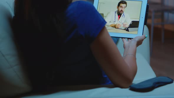 Woman Talking with Doctor Using Tablet