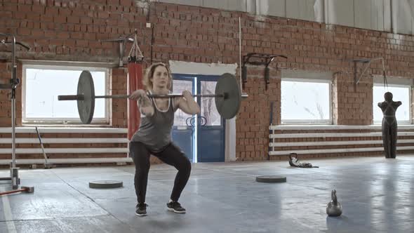 Woman Squatting with Weighted Barbell