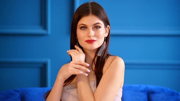 Portrait of a Girl in the Studio on a Blue Background.