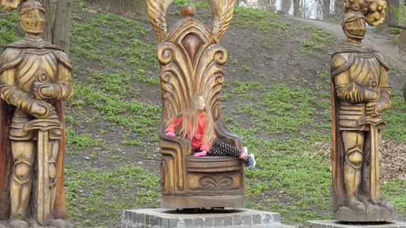 Junior Schoolgirl Blonde Sits and Poses on Large Chair