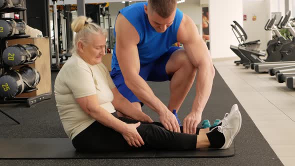 Coach Probes Muscles of Pensioner Old Woman Suffers Senior Concept