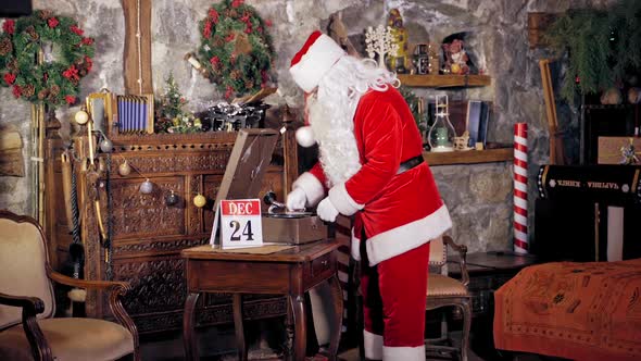 Santa Claus preparing for Christmas. View of Santa Claus listening music and waiting for Christmas