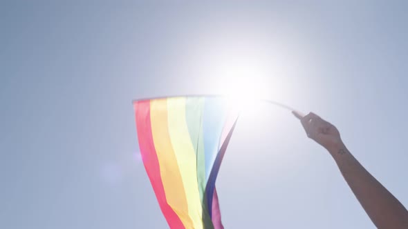 LGBTQ rainbow flag waving in slow motion during the main party in a pride parade