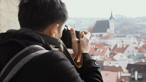 Young Asian Traveling Backpacker Taking Photos in City Centre in Europe