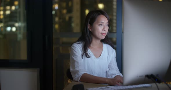 Woman work on computer at night