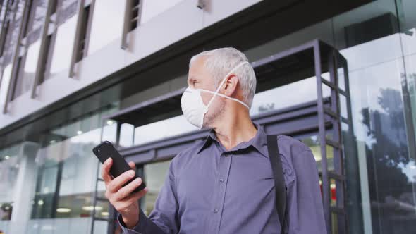 Caucasian man out and about in the street wearing on a face mask against coronavirus